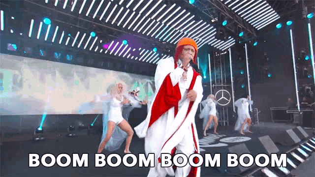 a man is dancing on a stage with the words boom boom boom boom