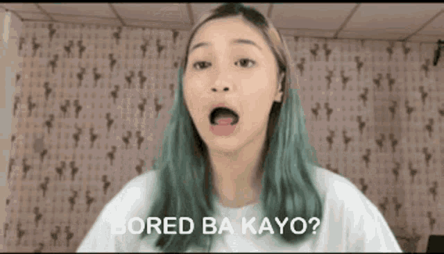 a woman with green hair says bored ba kayo in front of a wall with keys on it