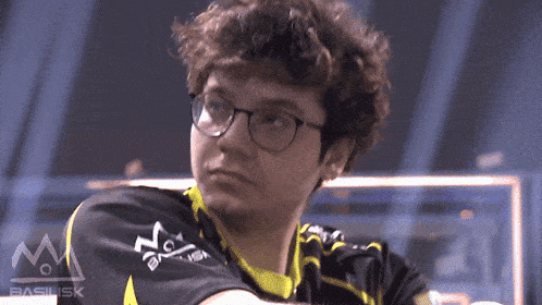 a person wearing glasses and a shirt that says basilisk on it