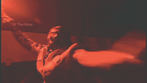 a photo of a man in a dark room with the name the maw at the bottom