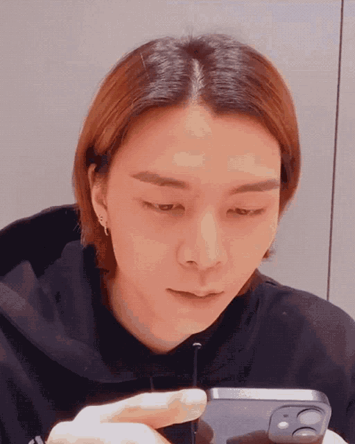 a close up of a person looking at their phone
