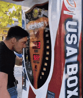 a man looking at a boxer machine that says usa box on it