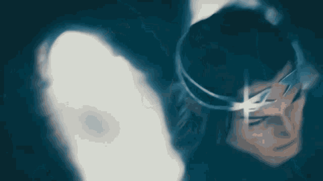 a woman with long hair is standing in a dark tunnel