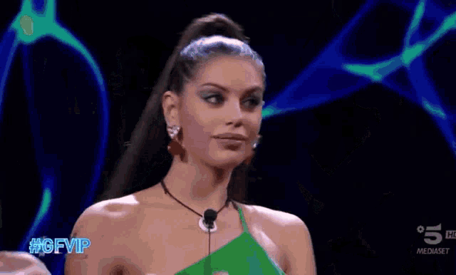 two women are dancing in front of a screen that says #gfvip on it
