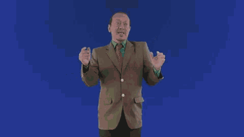 a man in a suit and tie is giving a middle finger