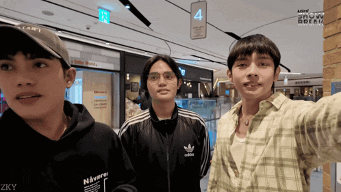 a group of young men are standing in front of a sign that says 4
