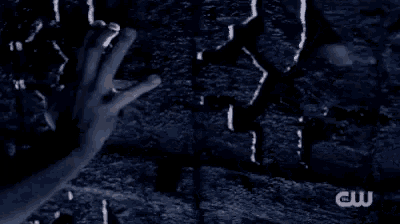 a man is laying on the ground in a dark room with his head on the ground .