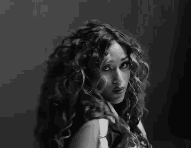 a black and white photo of a woman 's face with long hair