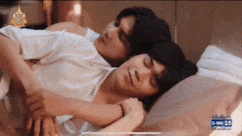 a man and a woman are sleeping on a bed together .