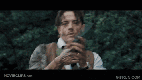a close up of a man holding a gun in a movie clip