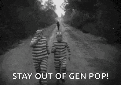 a black and white photo of two prisoners running down a road .