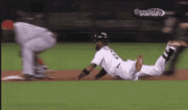 a baseball player is sliding into second base while another player tries to catch the ball .