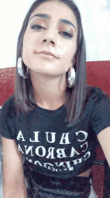 a woman wearing a black t-shirt that says " a juho "