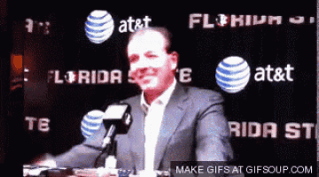 a man in a suit stands in front of a sign that says florida