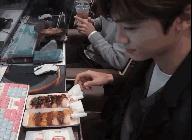 a man is eating a sandwich with a wrapper that says ' king ' on it