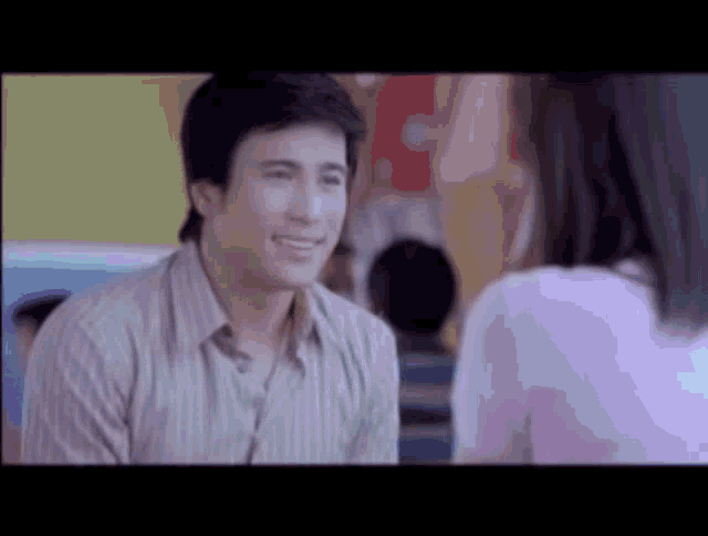 a man and a woman are talking to each other and the man is smiling