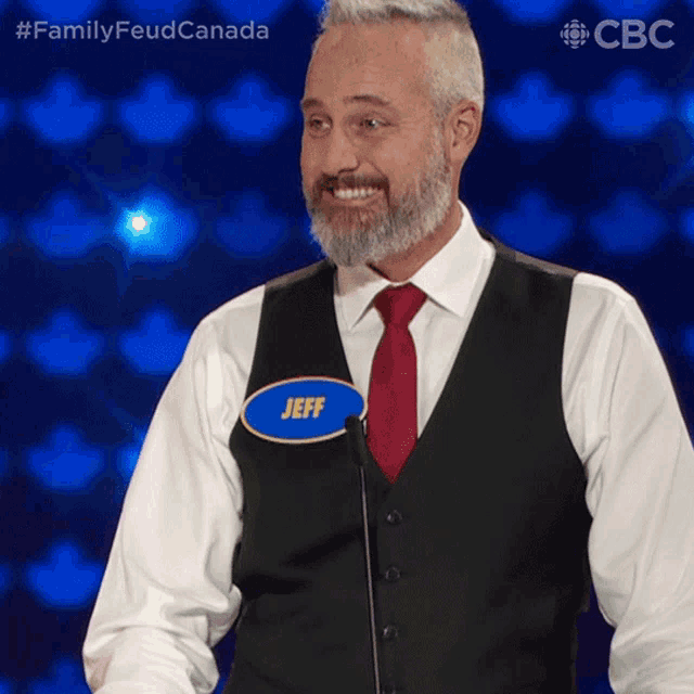 a man with a name tag that says jeff stands in front of a microphone