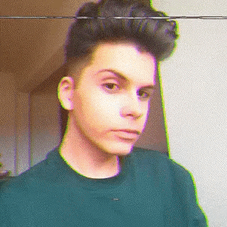 a pixelated portrait of a young man with a green shirt