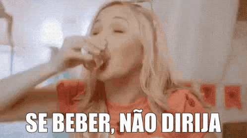 a woman is drinking from a glass with the words se beber , nao dirija above her