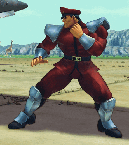 a man in a red uniform with silver armor and a belt with the letter t on it