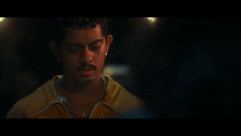 a close up of a man wearing a yellow jacket