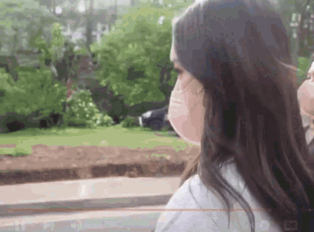 a woman wearing a mask is looking at something
