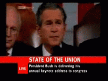 a tv screen shows president bush delivering a keynote address to congress