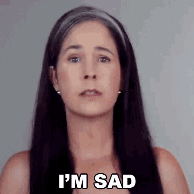 a woman with long black hair is saying i 'm sad .