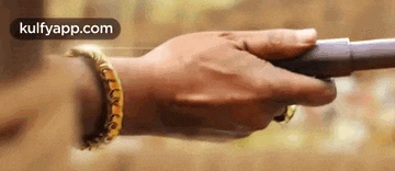 a person is holding a pipe in their hand .
