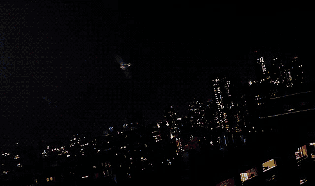 a man in a superhero costume is flying through the air with his wings spread