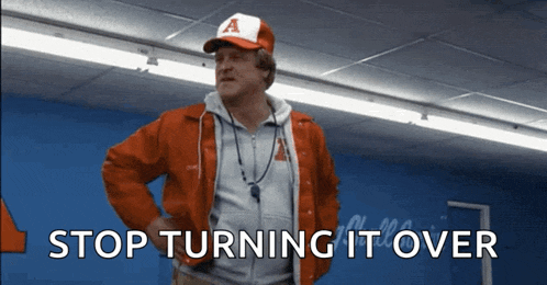 a man wearing a red jacket and a baseball cap says stop turning it over