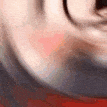 a blurred image of a person 's face with a red and white background