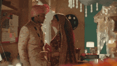 a bride and groom looking at each other in a bedroom