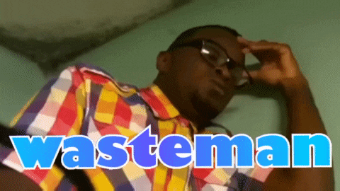 a man wearing glasses and a colorful shirt with the word wasteman written on it