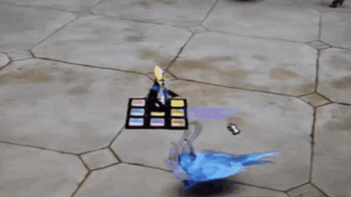 a blue bird with horns is standing on a tiled floor next to a display of cards