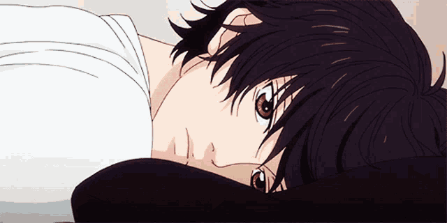 a black haired anime character is laying on a bed