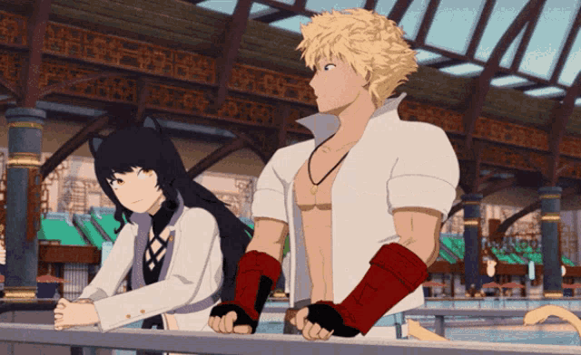 a man and a woman standing next to each other on a railing
