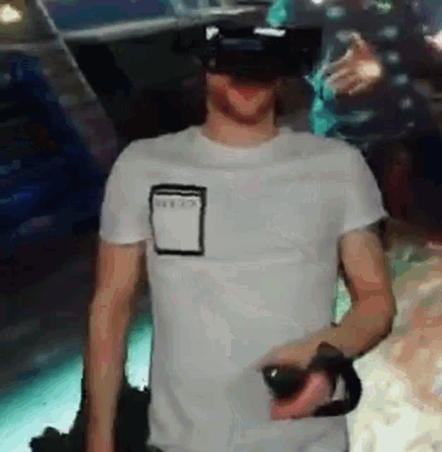 a man wearing a virtual reality headset is holding a controller ..