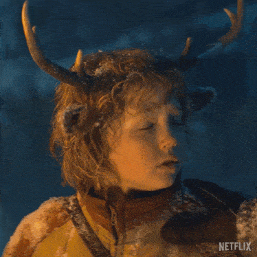 a young boy with antlers on his head and a netflix logo in the background