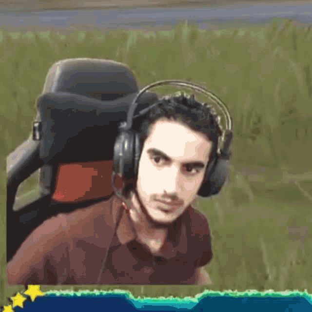 a man wearing headphones sitting in a chair