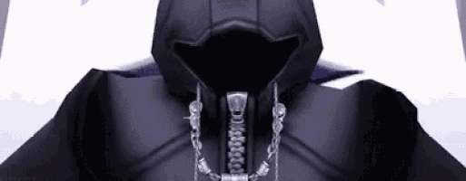 a close up of a person wearing a black hooded jacket with chains around their neck .