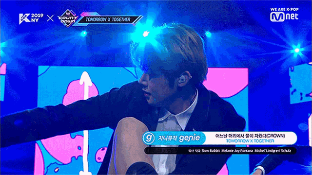 a man in a suit is on a stage with a sign that says tomorrow x together