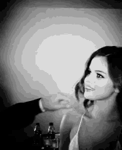 a black and white photo of a woman with a man 's hand on her shoulder