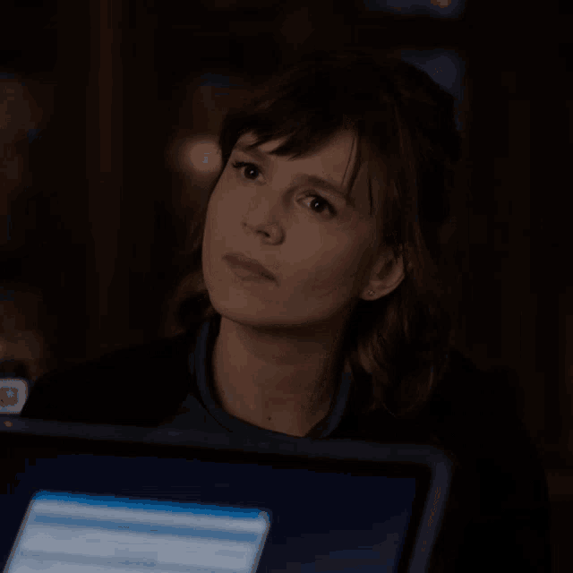 a woman says " that 's odd " in front of a computer screen
