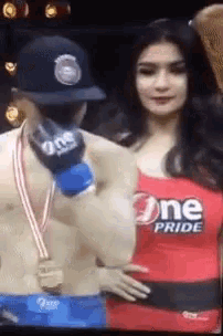 a woman in a one pride outfit stands next to a man