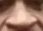 a blurry picture of a woman 's nose with a blurred background .