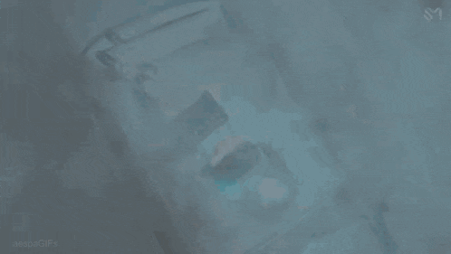 a woman is laying on the roof of a car with the letter s visible