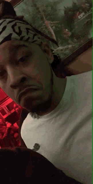 a man wearing a headband that says gf on it looks at the camera