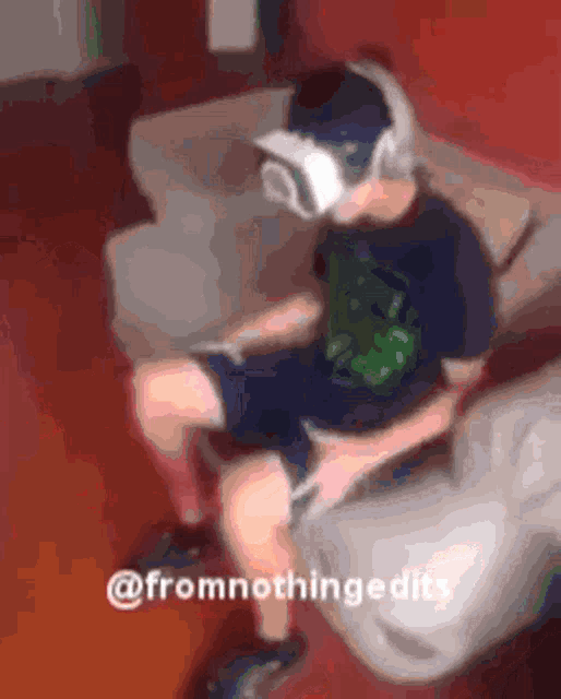 a person wearing a virtual reality headset is sitting on a couch ..