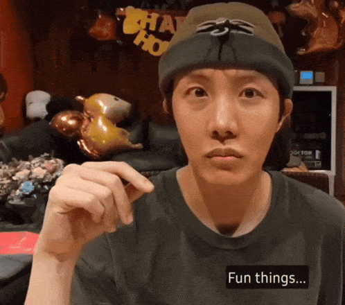 a man wearing a beanie and a t-shirt that says fun things